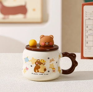 Detail of cute bear ceramic mug with Dreams Come True text and wavy handle design