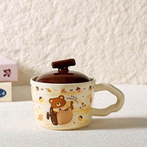 Detail of creative ceramic bear mug featuring wavy handle and brown lid with T-shaped knob