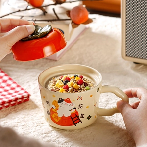 Close-up of ceramic mug with lucky cat patterns and Persimmon shaped lid for breakfast