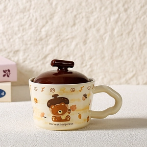 Detail of cute bear ceramic mug with wave handle, acorn lid, and Harvest Happiness print