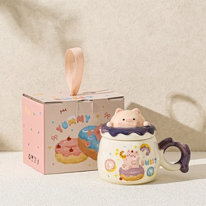 Close-up of ceramic pig mug with a 3D pig lid and matching pink gift packaging box
