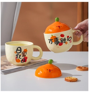 Close-up of ceramic mug with citrus lid design and festive calligraphy patterns