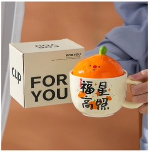 Detail of creative ceramic mug with persimmon lid and festive gift box packaging