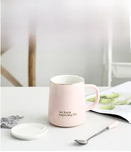 Pink ceramic mug with gold rim and let keep enjoying life text, including lid and spoon