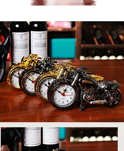 Macro shot of vintage style creative motorcycle table clocks in gold and black finishes