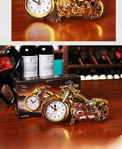 Detailed view of the golden motorcycle clock with quartz dial in its retail packaging