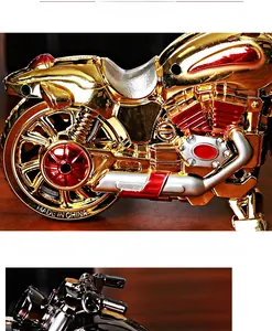 Macro shot of gold motorcycle alarm clock featuring detailed metallic finish and red hubs
