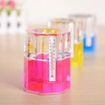Close-up of three hexagonal liquid thermometers in red, yellow and blue colors