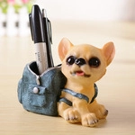 Creative resin dog pen holder with blue backpack storage on a wooden desktop