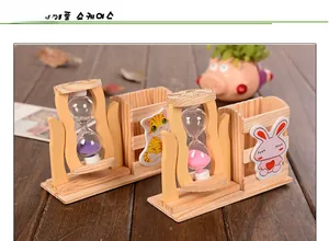 Detail showing wooden pencil holder with rotating hourglass and cartoon animal stickers