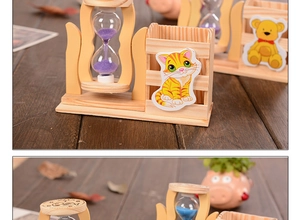 Detail of wooden pencil holder with colorful sand hourglass and cute cartoon animal stickers