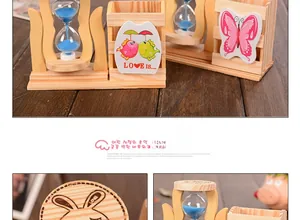 Detail of wooden pencil holder with rotating blue sand hourglass and cartoon bear carving
