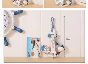 Detail of Mediterranean anchor wall decor with thermometer and resin sea shells