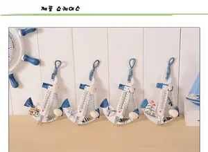 Detail of wooden anchor thermometers with seashells and fishnets in nautical style