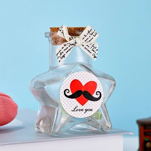 Star-shaped glass wishing bottle with cork stopper and decorative ribbon detail