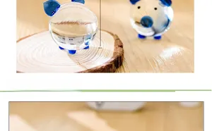 Macro detail of a 40mm crystal pig figurine with blue accents on a rustic wood base