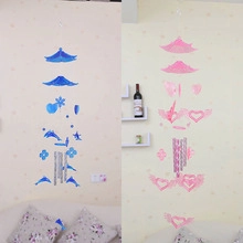 Detail view of blue and pink ceramic wind chimes featuring dolphin and heart-shaped charms