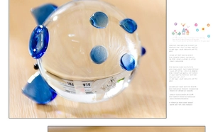 Macro shot of a clear crystal pig ornament with textured blue decorative glass studs