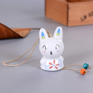 Cute ceramic rabbit wind chime with floral pattern and wooden beads on hanging rope