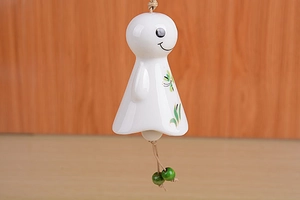 Detailed ceramic wind chime with hand-painted green leaves and wooden beads detail