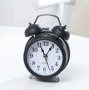 Classic black vintage twin bell alarm clock with matte metal finish and white dial display