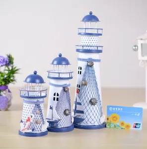 Mediterranean blue and white metal lighthouse set with seashell and anchor details