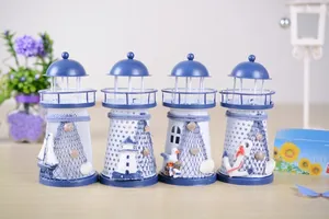 Detailed close-up of blue and white Mediterranean style lighthouse ornaments with shells