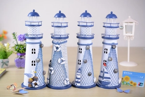 Detail of blue and white Mediterranean iron lighthouse set with shells and fish nets