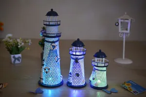 Three Mediterranean metal lighthouse lamps with glowing LED nautical anchors and nets