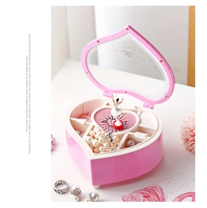 Detail of pink heart-shaped music box with rotating ballerina and jewelry storage compartments