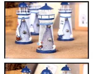 Detail of Mediterranean lighthouse decor with mini seashells, fishing nets and seagulls