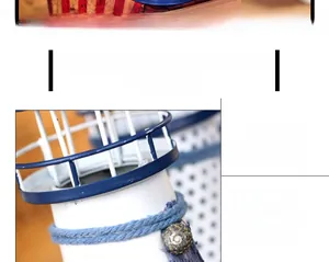Detailed close-up of a blue and white Mediterranean metal lighthouse with shells