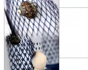 Detail of Mediterranean lighthouse decor with blue fishing net and real seashells