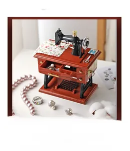 Detail of vintage sewing machine music box with jewelry storage drawer and pearl accents