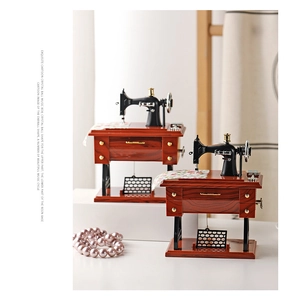 Close-up of vintage sewing machine music box with intricate details and wooden texture