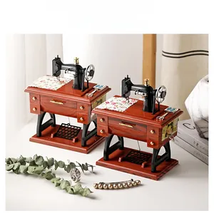 Detail of vintage sewing machine music boxes with miniature scissors and floral fabric
