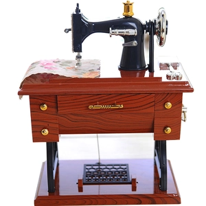 Vintage mini sewing machine music box with floral fabric and wood grain base