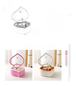 Detail of heart-shaped musical jewelry box with rotating ballerina and inner mirror
