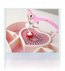 Macro detail of rotating ballerina inside heart-shaped music box with velvet grid lining