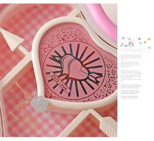 Detail of pink heart-shaped music box with gold rose pattern and Only Love engraving