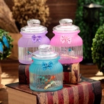Three-piece frosted glass jar set with embossed stripes, decorative bows, and ball lids