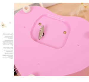 Detailed macro view of the mechanical wind-up key and base of the heart music box