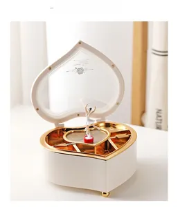 Detail view of heart-shaped music box with a rotating ballerina and built-in vanity mirror
