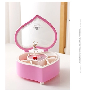 Detailed view of heart-shaped music box with ballerina mirror and jewelry storage