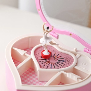 Pink heart-shaped music box with rotating ballerina girl and jewelry storage compartments