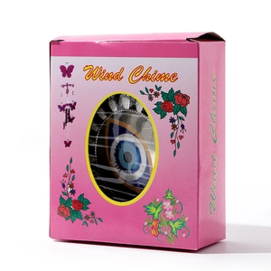 Detailed view of pink wind chime gift box with evil eye glass pendant and floral designs