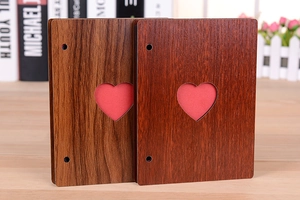 Detail of 6-inch wooden photo album with hollow heart design and ring binder structure