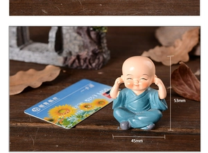 Detail view of monk figurine in blue robe with 53mm height and 45mm width dimensions