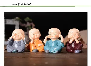Detail of four colorful resin Shaolin monk figurines in classic zen poses