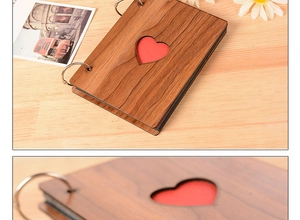 Detail of 6-inch heart wood photo album with silver rings and hollow heart cover design